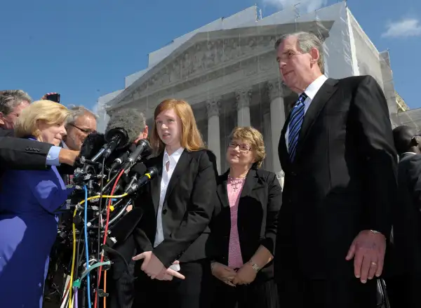 Abigail Fisher, the Texan involved in the University of Texas affirmative action case, accompanied by her attorney Bert Rein, right, talks to reporters outside the Supreme Court in Washington, October 10, 2012.