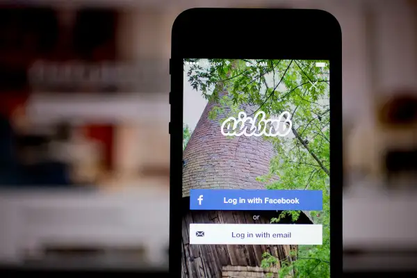 The Airbnb application and website are displayed on an Apple iPhone and iPad on March 21, 2014.