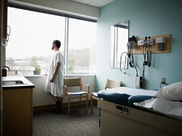 man in hospital room