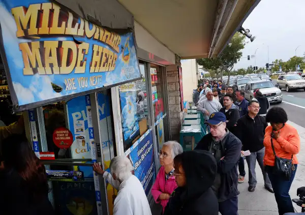 Customers wait in line at the Blue Bird Liquor Store to buy Powerball lottery tickets in Hawthorne, California on January 9, 2016.