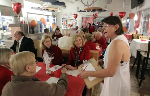 Waitress Joyce Jackson takes orders from customers at a White Castle restaurant in Kirkwood, Missouri on February 14, 2013. The burger joint, home of the 69 cent slider, converts itself on into a romantic eating establishment with tablecloths, candles and table service for dinner on Valentines Day.