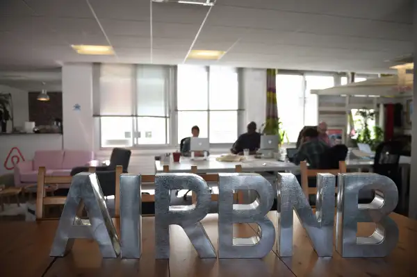 Employees of online lodging service Airbnb work in the Airbnb offices in Paris on April 21, 2015.