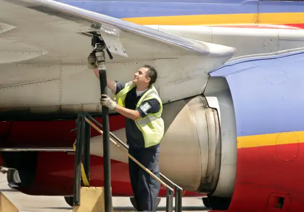 An aviation ground crew member pumps fuel into a Southwest Airlines' plane April 23, 2008, at Los Angeles International Airport.