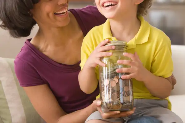 mother and son with jar of coins