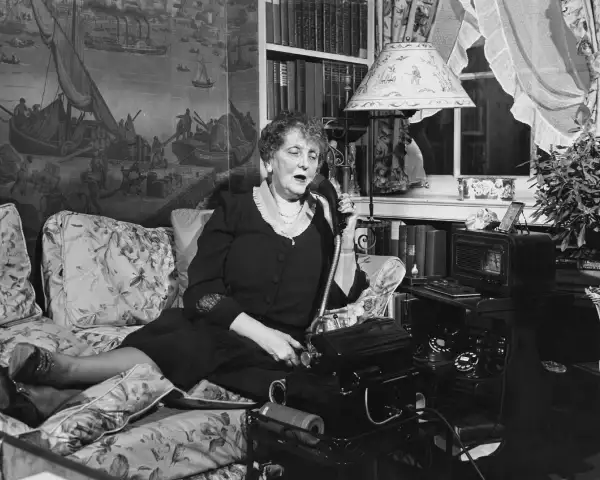Writer Emily Post (1872-1960) pictured in her living room speaking on the telephone, USA, circa 1940. An author on the subject of etiquette, Post founded the Emily Post Institute in 1946, an organisation providing etiquette experts and advice.