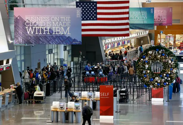 Passengers line up at the security checkpoint in terminal A at Logan International Airport in Boston, November 26, 2014.