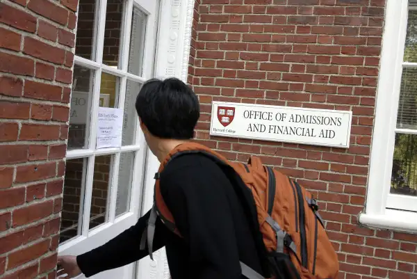 Freshman Winston Yan enters the Admissions Building at Harvard University September 12, 2006 in Cambridge, Massachusetts.
