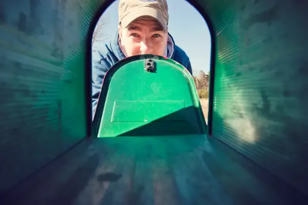 man looking in mailbox