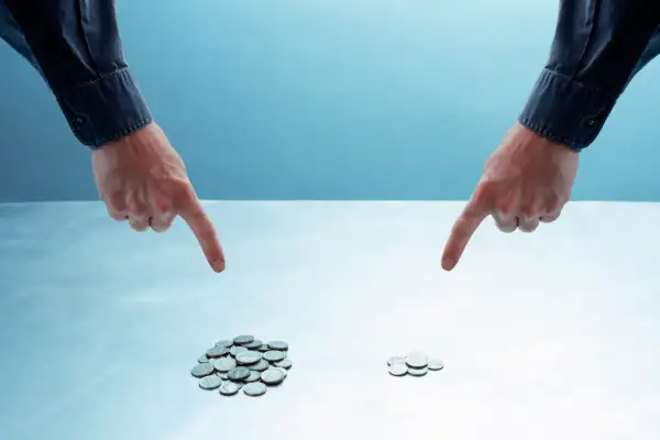 hands pointing at different piles of coins