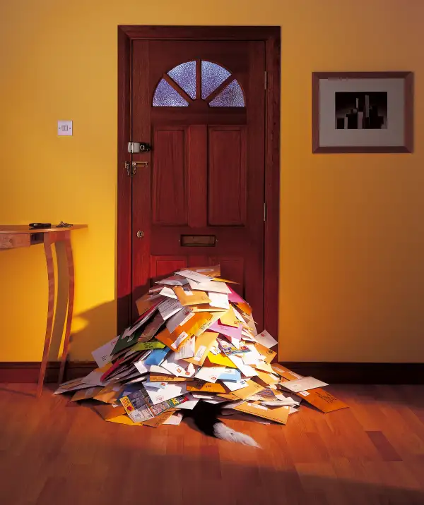 pile of junk mail inside door