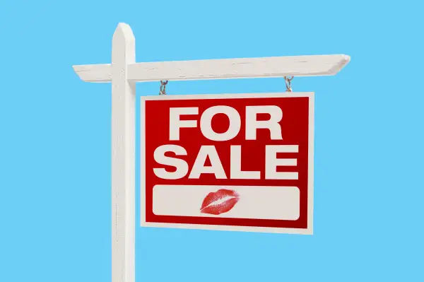 Home For Sale sign with lipstick mark