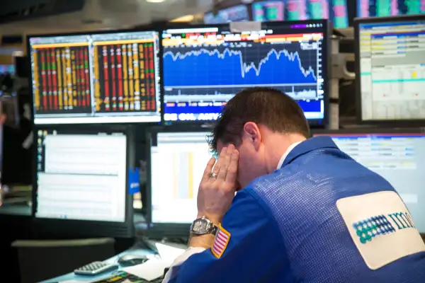 A trader works on the floor of the New York Stock Exchange (NYSE) in New York, on February 11, 2016. Global equities tumbled toward a bear market, with the Dow Jones Industrial Average plunging to 400 points, as financial markets signaled that investors have lost faith in central banks' ability to support the worldwide economy.