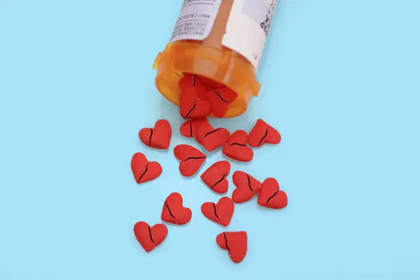 pill bottle spilling out broken heart pills