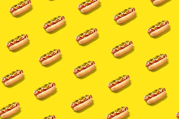 Hot dogs on yellow background