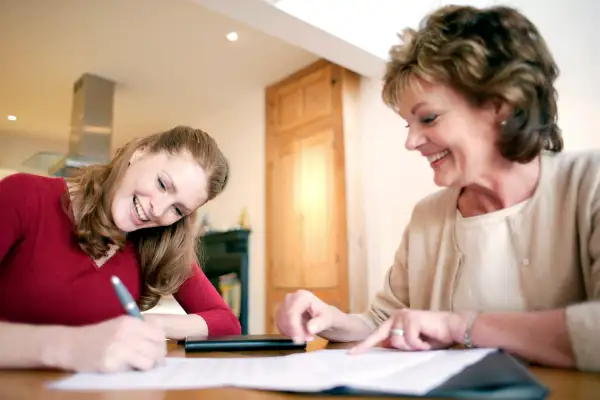 Mother with daughter signing document