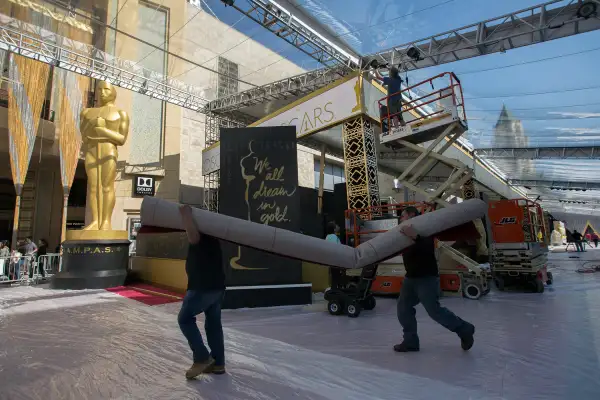 Workers prepare the red carpet arrival area on Hollywood Boulevard for the 88th Annual Academy Awards at Hollywood & Highland Center on February 25, 2016 in Hollywood, California.