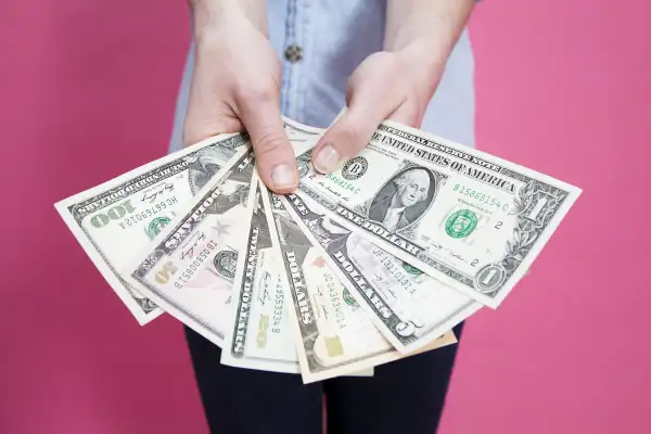 woman holding fan of money