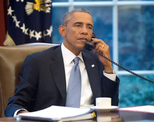 President Obama Works In The Oval Office Of White House