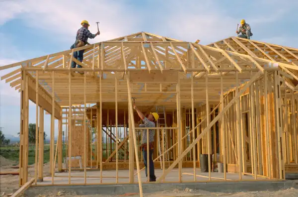 carpenters framing a house
