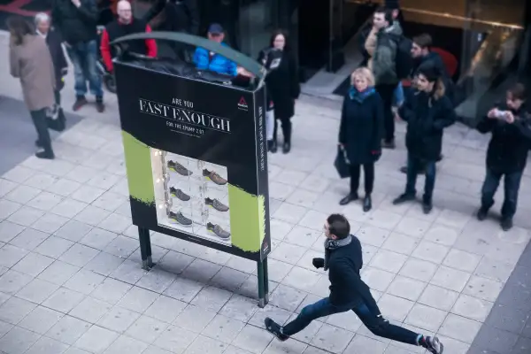 man running past reebok ad