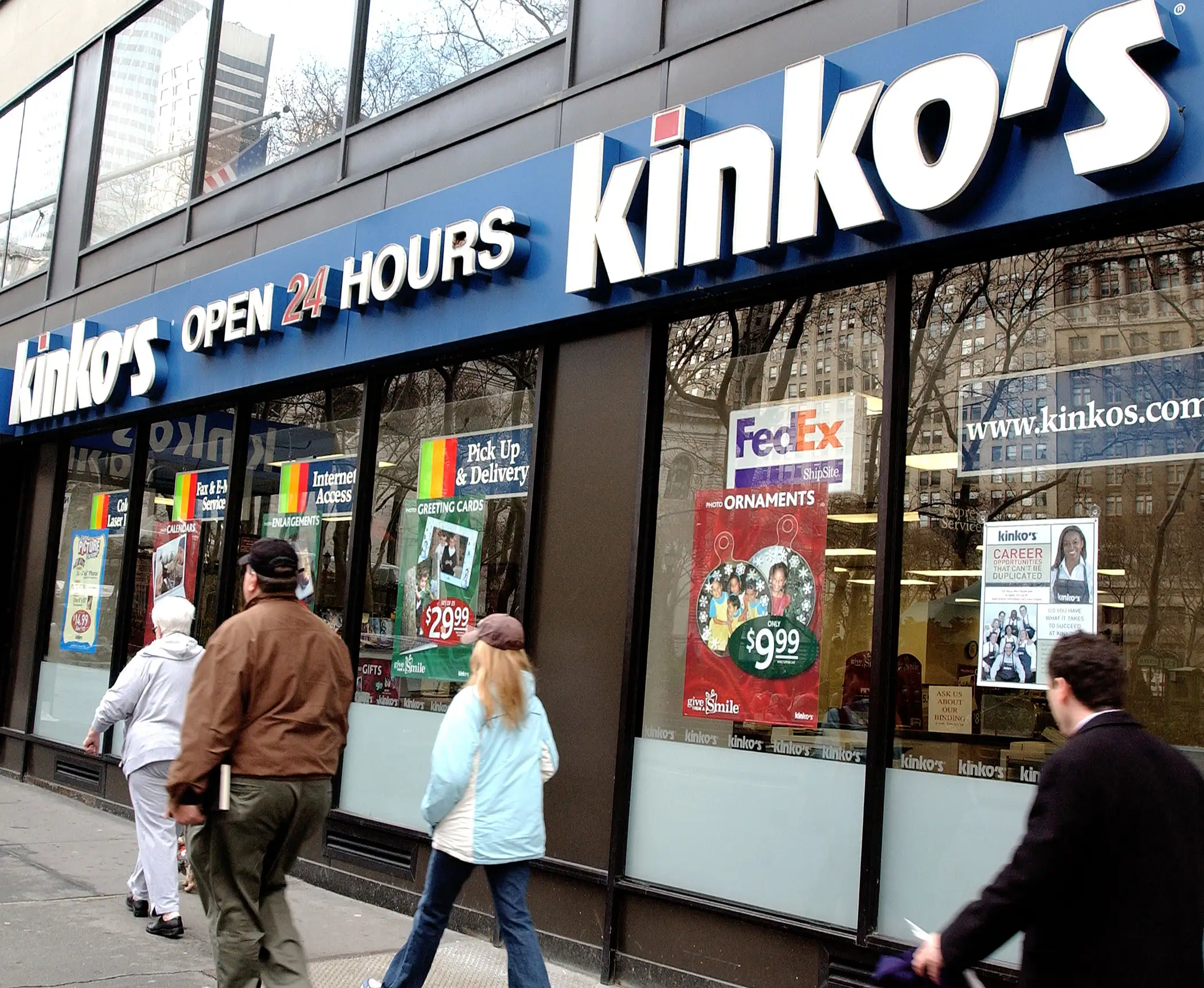Pedestrians pass by a Kinko's store December 30, 2003 in New York City.