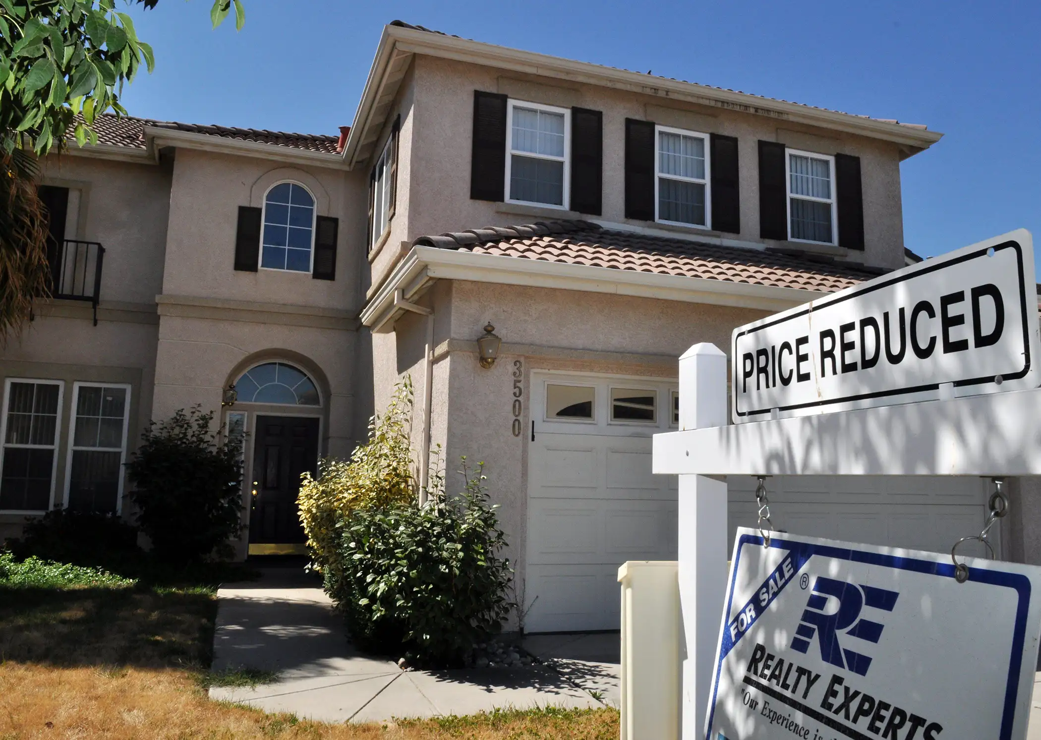 price reduction sign on house