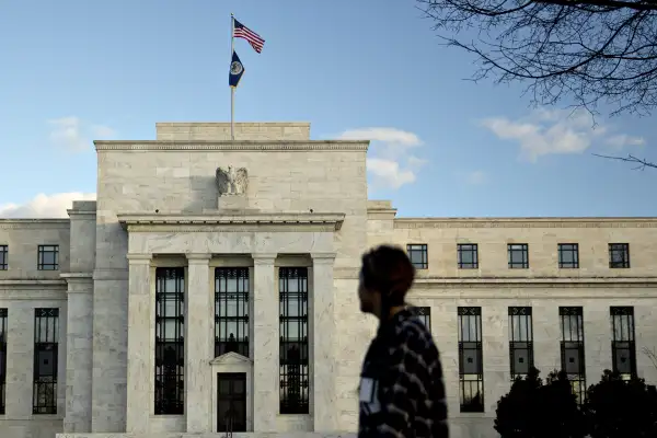 A pedestrian walks past the Marriner S. Eccles Federal Reserve building in Washington, D.C., U.S., on December 15, 2015.