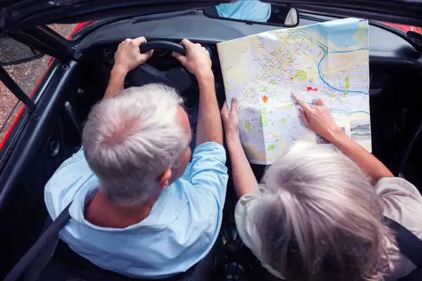 people consulting map in car