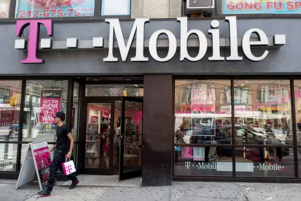A customer exits a T-Mobile US Inc. store in New York, on July 26, 2015.