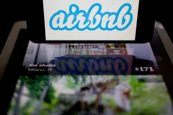 The Airbnb logo and application are displayed on an Apple iPhone and iPad in this arranged photograph in Washington, D.C., on March 21, 2014.