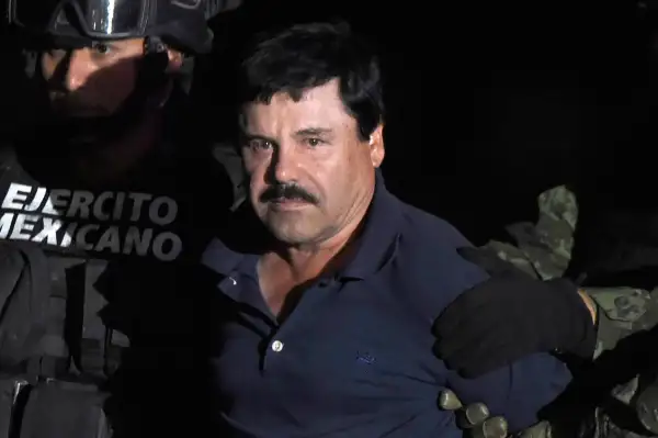 Drug kingpin Joaquin  El Chapo  Guzman is escorted to a helicopter at Mexico City's airport on January 8, 2016 following his recapture during an intense military operation in Los Mochis, in Sinaloa State. Mexican marines recaptured fugitive drug kingpin Joaquin  El Chapo  Guzman on Friday in the northwest of the country, six months after his spectacular prison break embarrassed authorities.