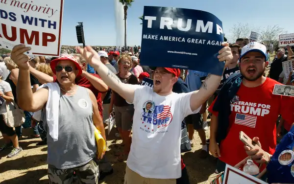 Supporters of Republican presidential candidate Donald Trump hold signs and chant his name during a campaign rally at Fountain Park during a campaign rally on March 19, 2016 in Fountain Hills, Arizona.