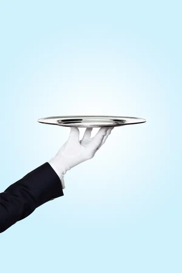 butler holding silver serving tray