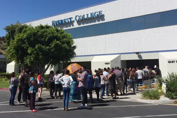 Students wait outside Everest College, Tuesday, April, 28, 2015 in Industry, Calif., hoping to get their transcriptions and information on loan forgiveness and transferring credits to other schools. Corinthian Colleges shut down all of its remaining 28 ground campuses on Monday, April 27, displacing 16,000 students. The shutdown comes less than two weeks after the U.S. Department of Education announcing it was fining the for-profit institution $30 million for misrepresentation.