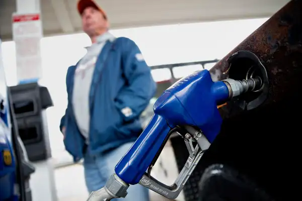 A customer fills up a vehicle with fuel at an Exxon Mobil Corp. gas station in Rockford, Illinois, on October 28, 2015.