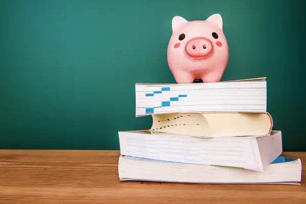 piggy bank on top of books