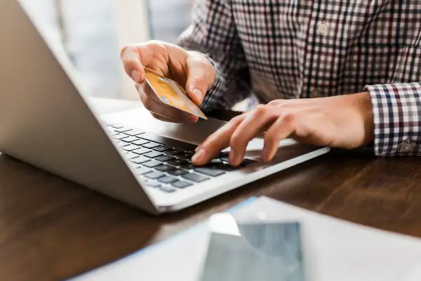 person using laptop to pay by credit card