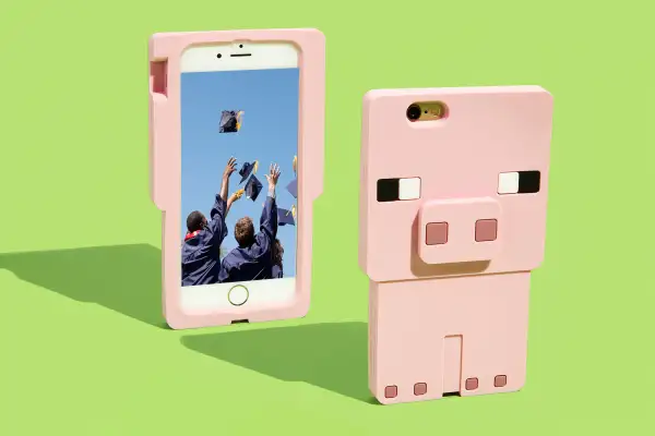 pig phone case with graduates tossing caps on screen of phone