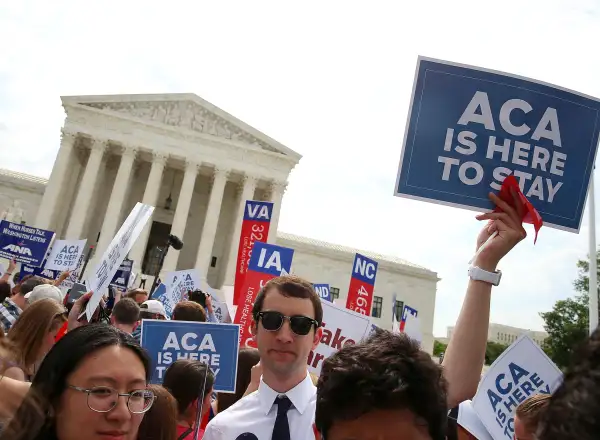 People celebrate in front of the US Supreme Court after the ruling was announced on the Affordable Care Act. June 25, 2015 in Washington, DC. The high court ruled that the Affordable Care Act may provide nationwide tax subsidies to help poor and middle-class people buy health insurance.