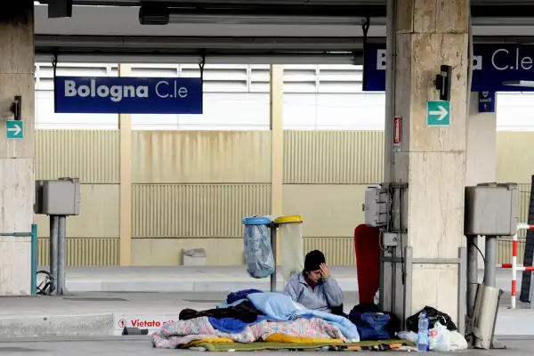 A homeless man sleeps at Bologna main railway station, Bologna, Italy, December 31, 2015.