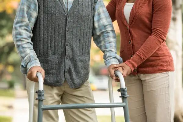 person helping man with walker