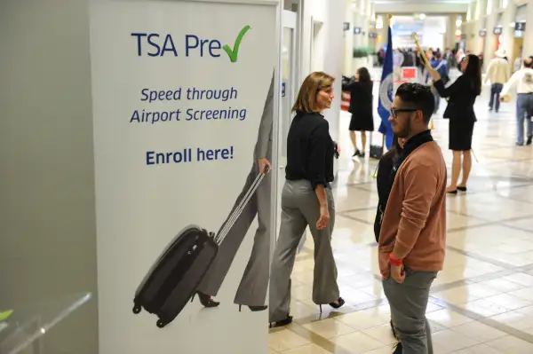 A poster announcing the Transportation Security Administration's (TSA) new Precheck program is seen outside the PreCheck enrollment office, at Los Angeles International Airport (LAX) on February 20, 2014 in Los Angeles, California. The TSA recently launched the PreCheck program that allows those enrolled in a trusted traveler network to enter about 100 US airports through a special security lane where they dont have to take off shoes, belts and jackets or remove laptops, liquids or gels.