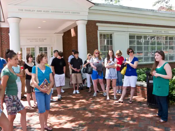 Parents and prospective students on student-led admissions office tour of Tufts University crossing campus.