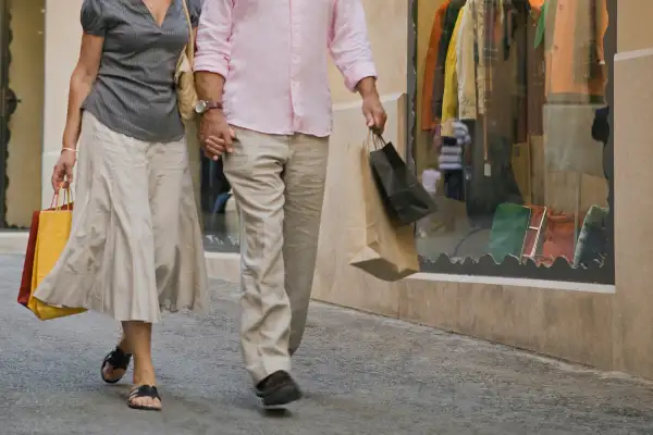 mature couple walking with shopping bags
