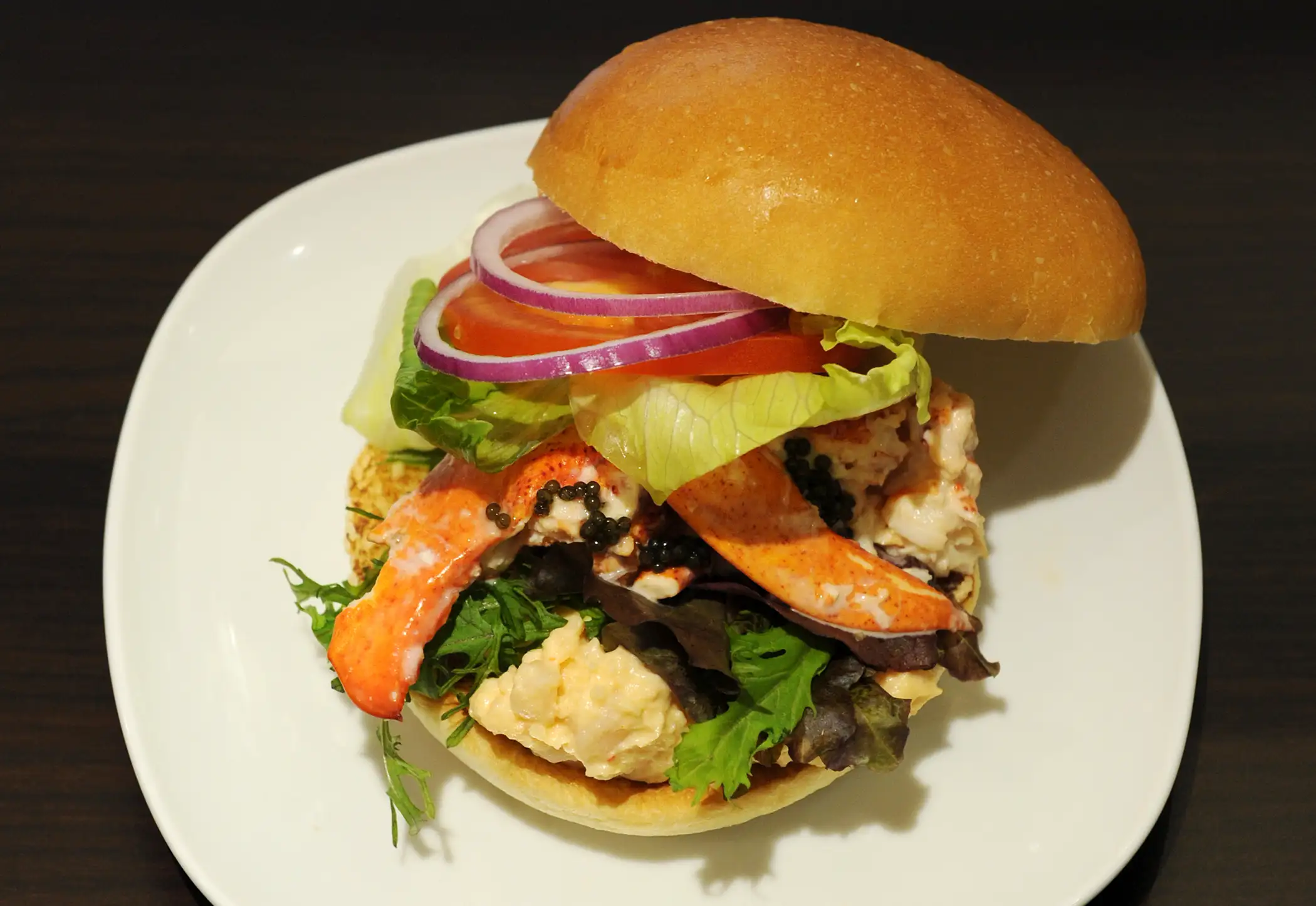 This picture shows the Lobster and Caviar burger featuring Canadian lobster and contains whole lobster pieces as well as a lobster salad made with a mustard mayonnaise as well as a sprinkle of caviar produced by Wendy's Japan as part of the campany's opening of their second restaurant in Roppongi, Tokyo on August 17, 2012. Wendy's Japan introduced two new burgers to their Japan Premium line of burgers which features fancy ingredients.
