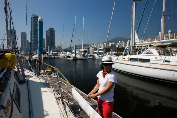 A woman holds a rope as a yacht leaves the Marina in the Haeundae district in Busan, South Korea, on July 31, 2015.