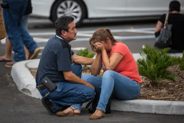Friends and family grieve after a list of hospitalized victims was released, implying the death of those who weren't on the list and hadn't been heard from, outside a Hampton Inn &amp; Suites hotel near the Orlando Regional Medical Center in Orlando, Fla., Sunday, June 12, 2016. A gunman opened fire inside a crowded nightclub early Sunday, before dying in a gunfight with SWAT officers, police said.