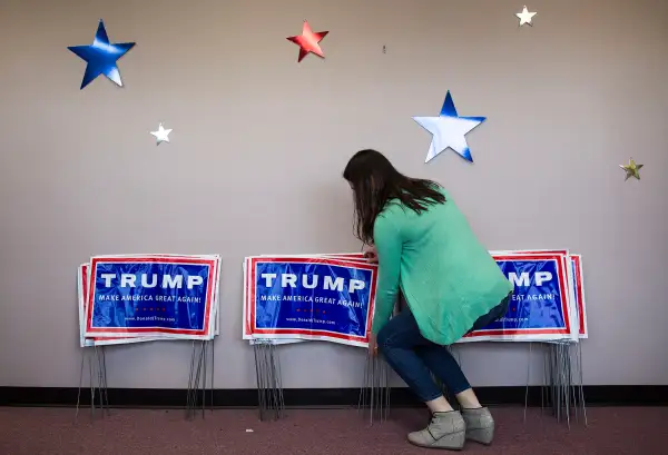 A campaign worker organizes campaign signs to be given out at the opening of the Donald Trump for President Raleigh campaign headquarters, in Raleigh, N.C., March 5, 2016.