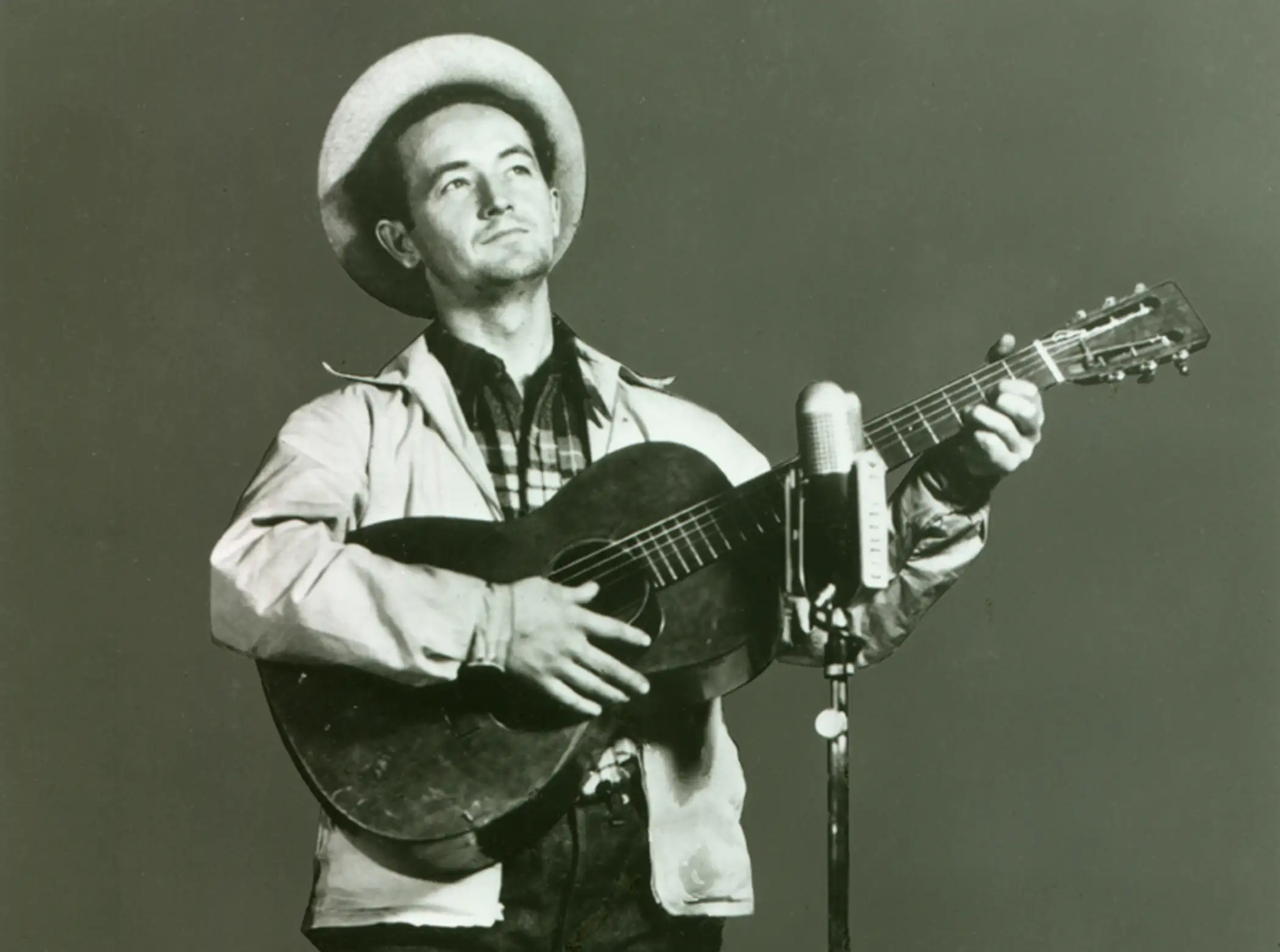 Woody Guthrie performing on “Back Where I Come From” radio show, WABC-CBS. New York City, 1940.