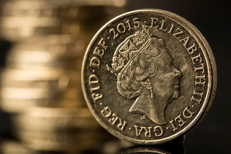 160627_INV_BritishPound A British one pound sterling coin stands in front of a stack of one pound sterling coins in this arranged photograph in Guildford, U.K., on Monday, June 13, 2016. Sterling swung on Monday as anxiety about Britains referendum on staying or leaving the European Union continued to build.